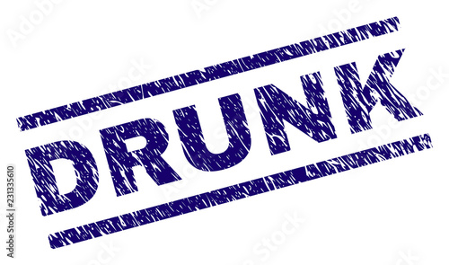 DRUNK seal print with distress style. Blue vector rubber print of DRUNK caption with scratched texture. Text title is placed between parallel lines.