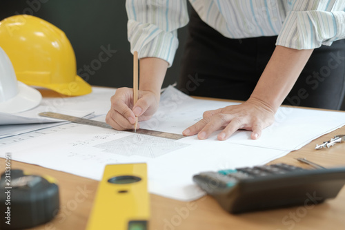 architect engineer working on house blueprint of real estate project at workplace. building construction concept