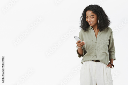 Konstfotografi Stylish and successful dark-skinned female african entrepreneur checking mail bo