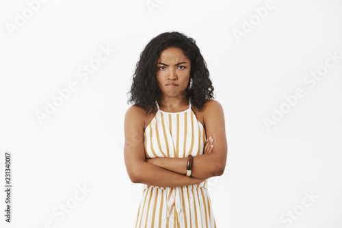 Fototapeta Portrait of angry and mad cute african american woman with curly hairstyle cross