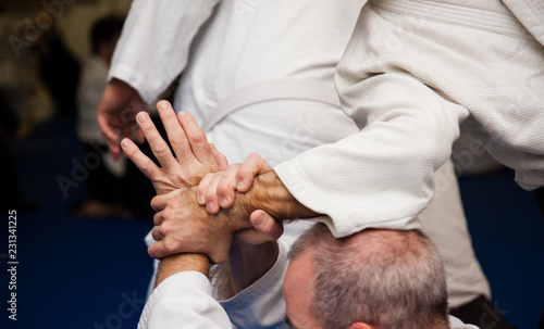 Aikido athletes train in the dojo. Aikidoki work out the elements of aikido equipment 