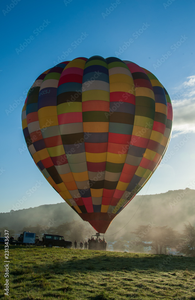 Obraz premium hot air balloon misty take off vertcal