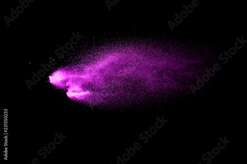 Pink dust particles splash on black background.