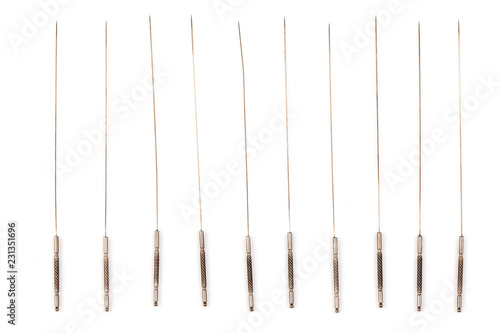 Silver needle acupuncture on an isolated white background. Close-up.