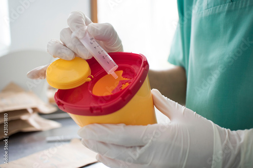 Wallpaper Mural Doctor put syringe in red disposal boxes. concept of pandemic, coronavirus, virus, disinfection, panic. Torontodigital.ca