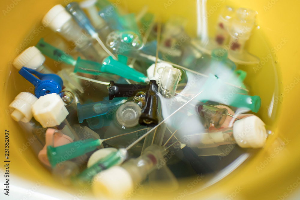 needles and syringes in disinfectant. disposal of medical needles and