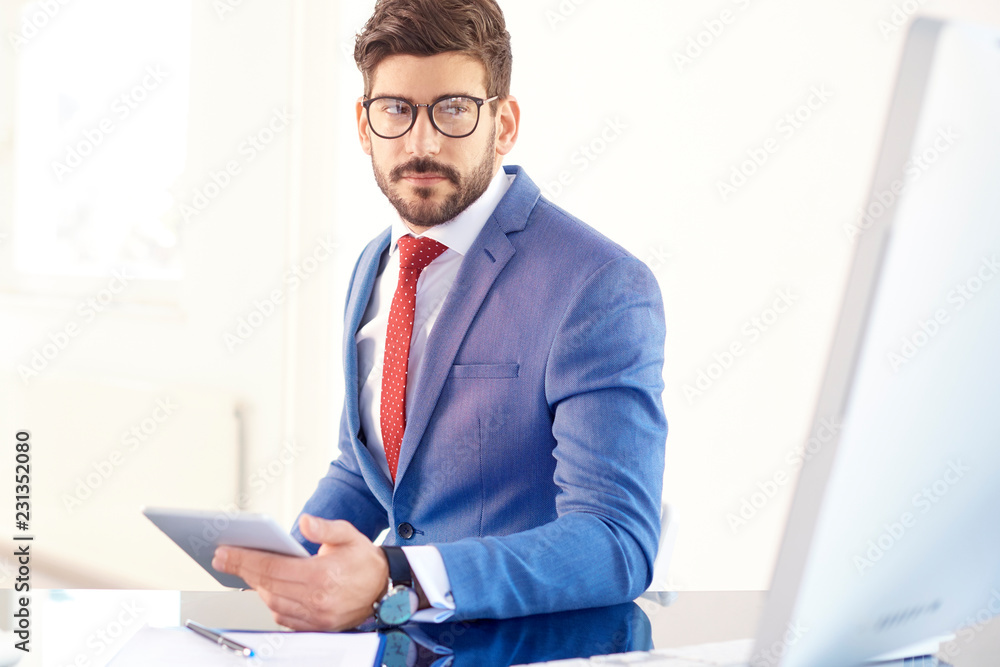 Thinking businessman working on digital tablet Thinking businessman working on digital tablet