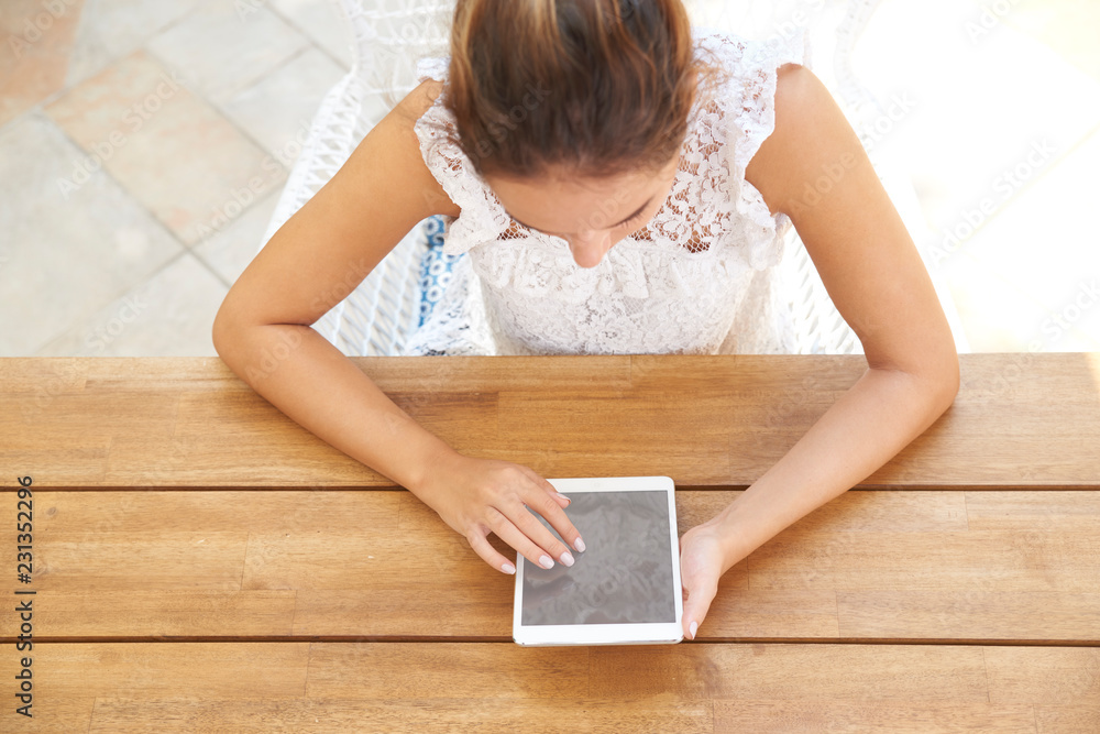 Woman using digital tablet while sitting at desk outdoor Woman using digital tablet while sitting at desk outdoor