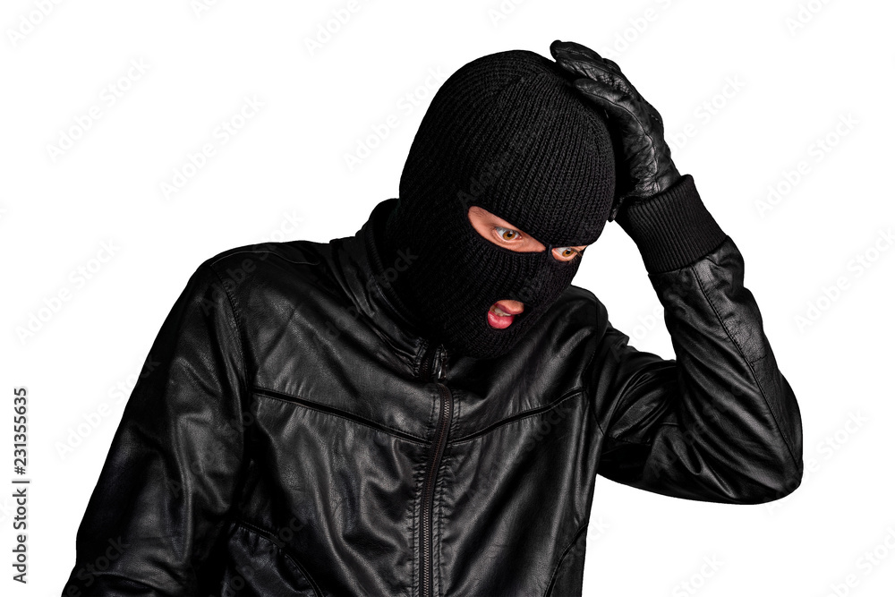 Thief in a mask grabbed his head, isolated on a white background Thief in a mask grabbed his head, isolated on a white background