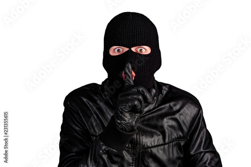 Thief in a mask showing sign quieter, isolated on a white background