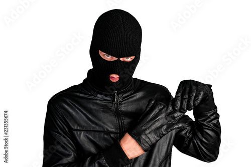 Thief in a mask takes off his glove, isolated on a white background