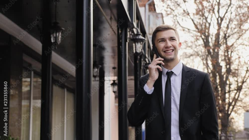 Young business man is talking on smart phone Young business man is talking on smart phone