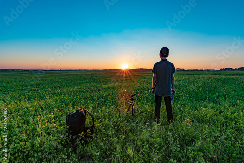 Boy looks at the sunset
