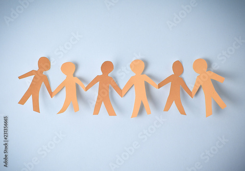 four paper men taking each other's hands