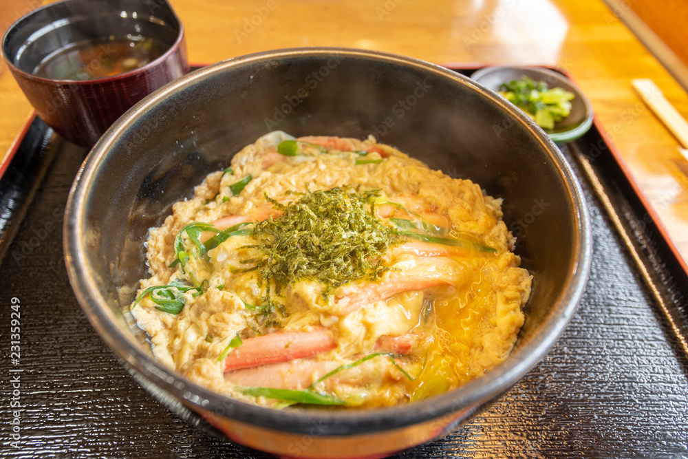 a bowl of rice with crab meat and eggs , japanese dish
