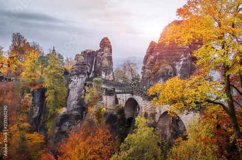 Wonderful Autumn Landscape. Incredible Foggy Morning in Saxon Switzerland National Park near Dresden at the Elbe river. Unsurpassed sunrise in the mountains Saxon Switzerland. Impressive nature Scene 