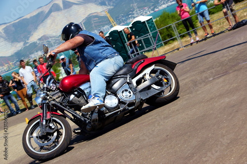 Fototapeta Naklejka Na Ścianę i Meble -  man riding motorcycle on road