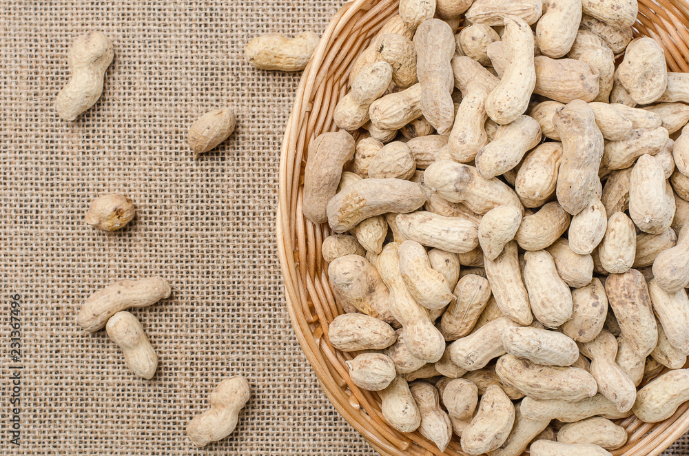 Peanuts in the peel on a light burlap. Peanuts in the peel on a light burlap.