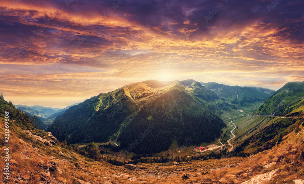 fantastic colorful landscape at sunset. overcast clouds glowing in sunlight, Beautiful summer landscape in the Fagarash mountains. artistic creative image. soft light effect. Transfagarasan road,