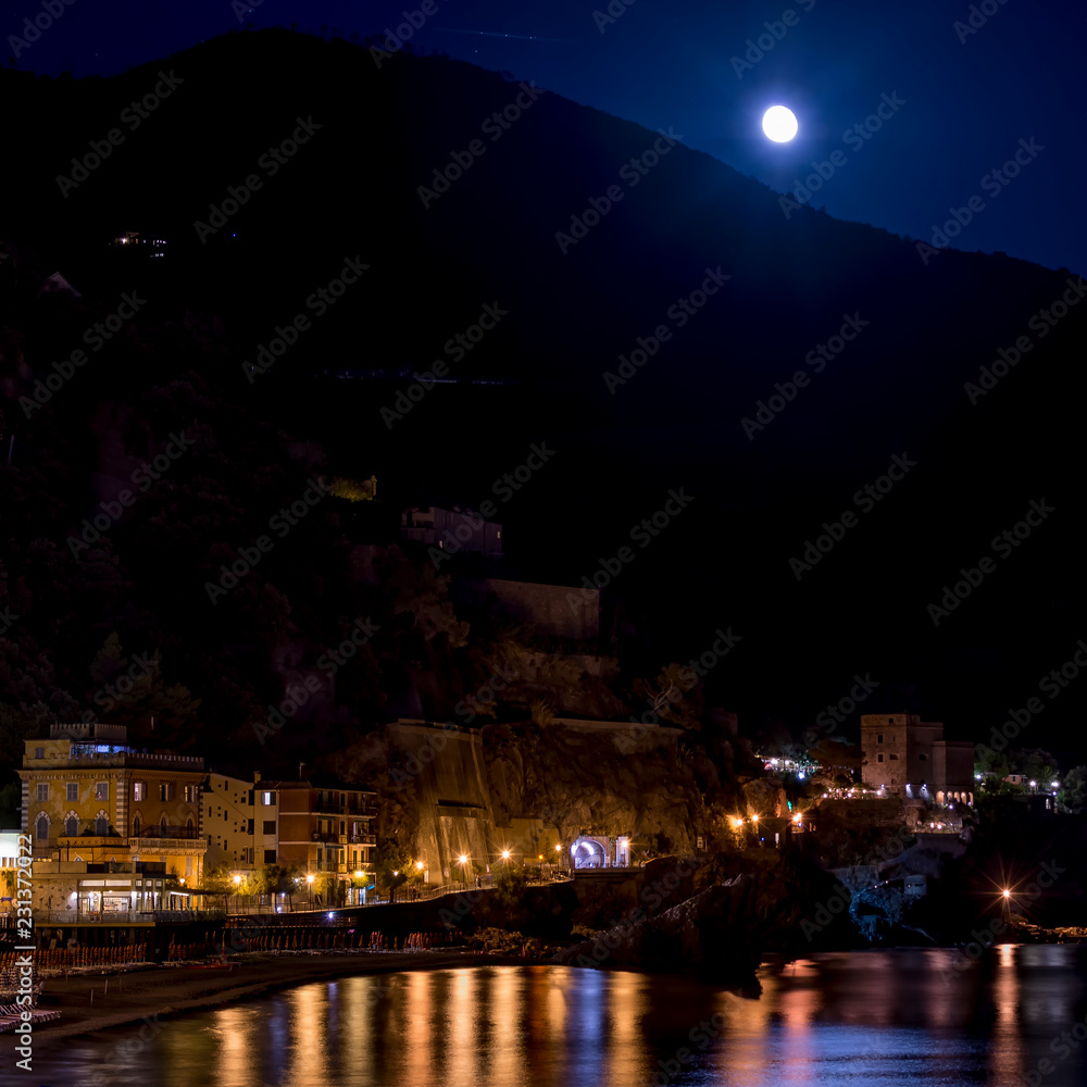 The moon rises from behind the mountain, Monterosso al mare, Cinque Terre, Liguria, Italy