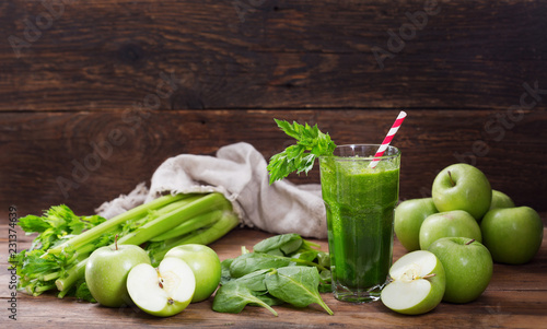 glass of green juice smoothie with spinach, apple and celery