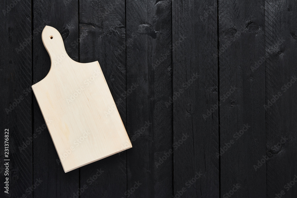 Top view of empty chopping board on black wooden table with copy space. Top view of empty chopping board on black wooden table with copy space.