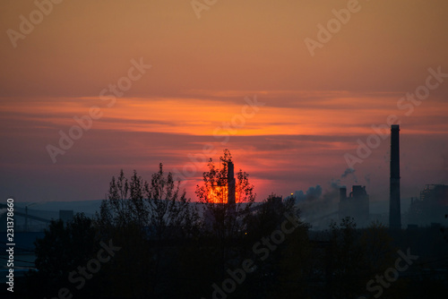 Fiery crimson sunset on the background of the city