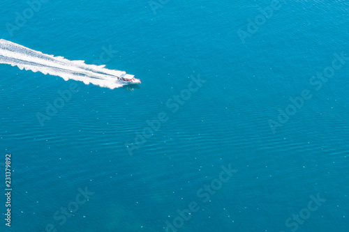 in the blue sea, surrounded by jellyfish, the boat swims fast