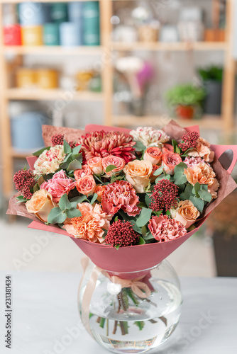 Fototapeta Naklejka Na Ścianę i Meble -  European floral shop. Bouquet Mixed beautiful flowers on wooden gray table. Nice garden flowers in the arrangement , the work of a professional florist.