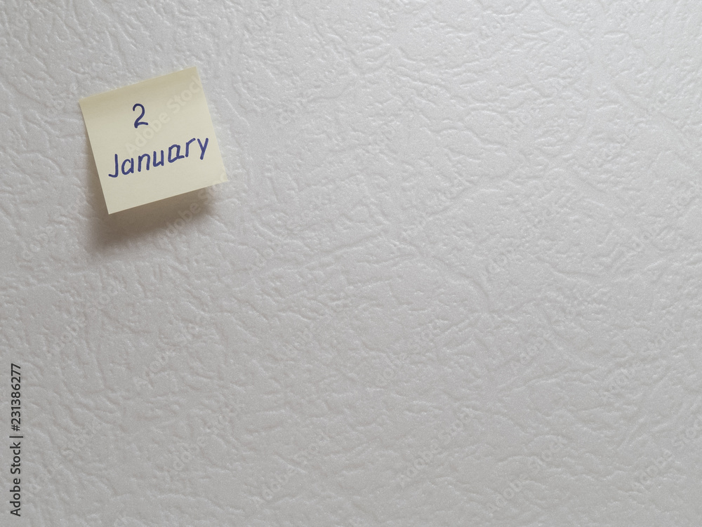 January 2: Calendar date on a yellow sticky note with copy space on white background. January 2: Calendar date on a yellow sticky note with copy space on white background.