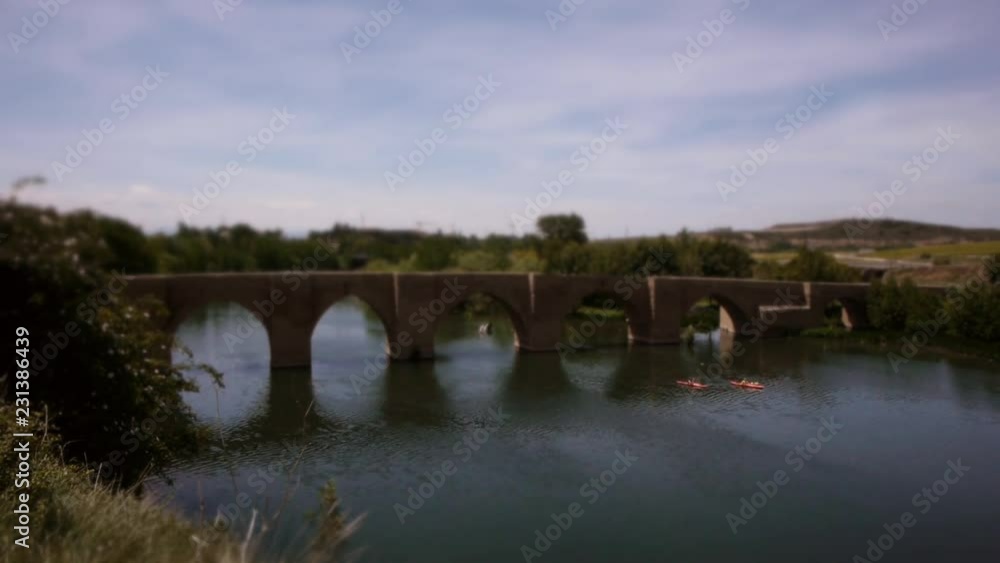 Tilt-Shift: Mini Kayak‘s paddle under bridge on river in La Rioja, Spain – wide Shot Tilt-Shift: Mini Kayak‘s paddle under bridge on river in La Rioja, Spain – wide Shot