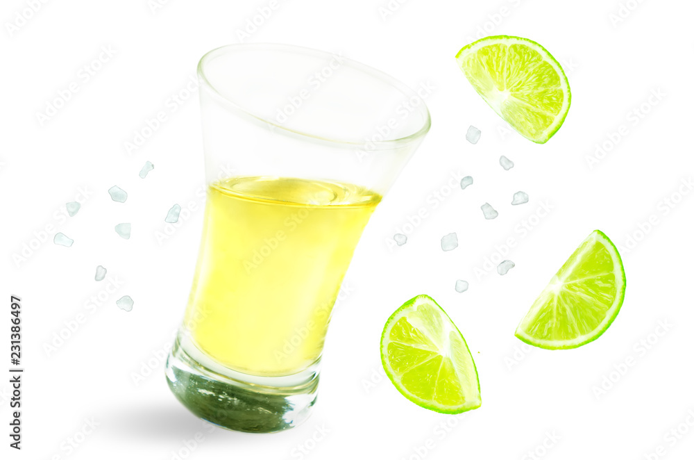 Glass of tequila liquor with falling salt and lime fruits isolated Glass of tequila liquor with falling salt and lime fruits isolated