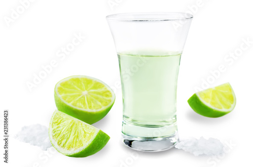 Glass of tequila liquor with salt and lime fruits isolated