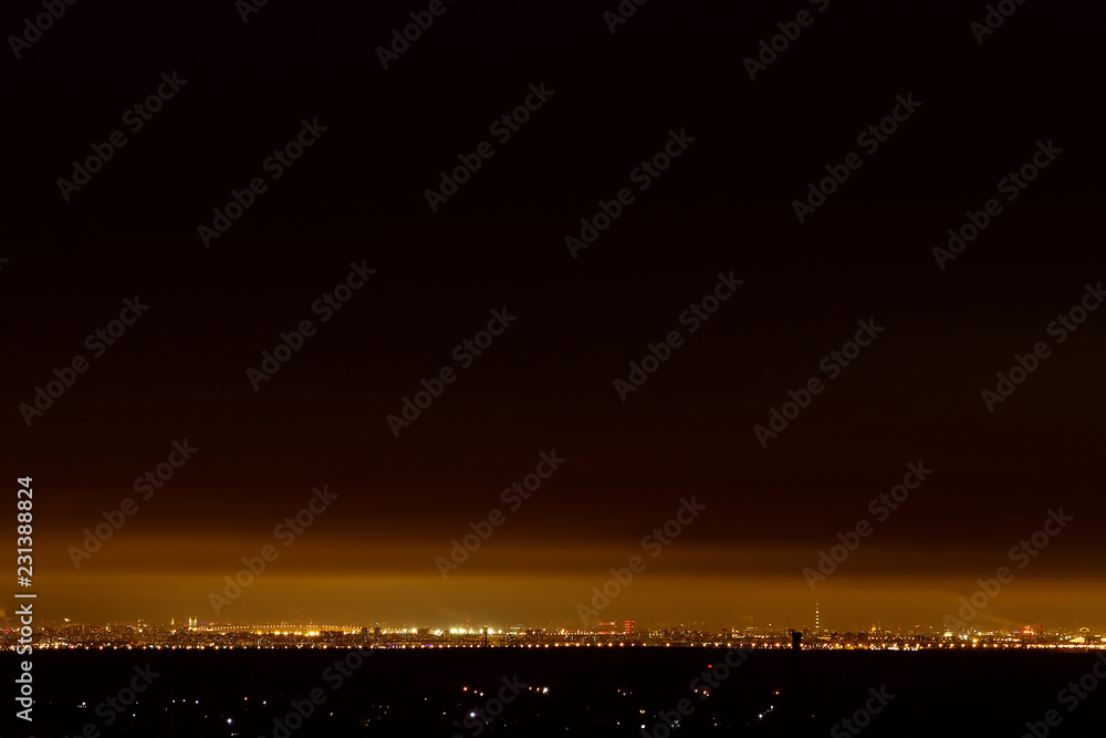 View from the hill on a slender night city at the foot View from the hill on a slender night city at the foot