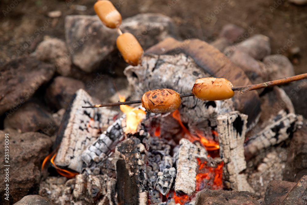 Fototapeta premium Cook sausages on the fire.