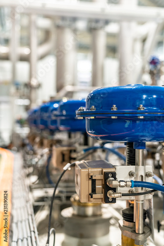 pneumatic valves in a row in a large industrial plant