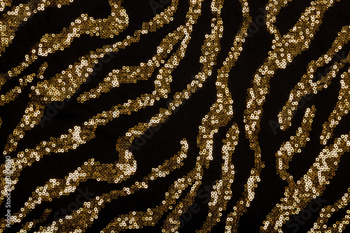 фотографія Black fabric with golden sequin pattern