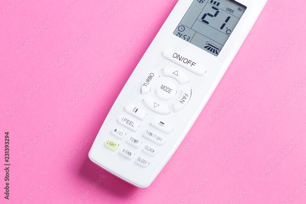 White remote control for air conditioning on a pink background close-up White remote control for air conditioning on a pink background close-up