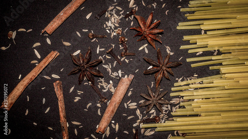 Fototapeta Naklejka Na Ścianę i Meble -  fettuccine pasta stick and the spices; cinnamon stick, star anise, cloves , cumin. food and culinary background