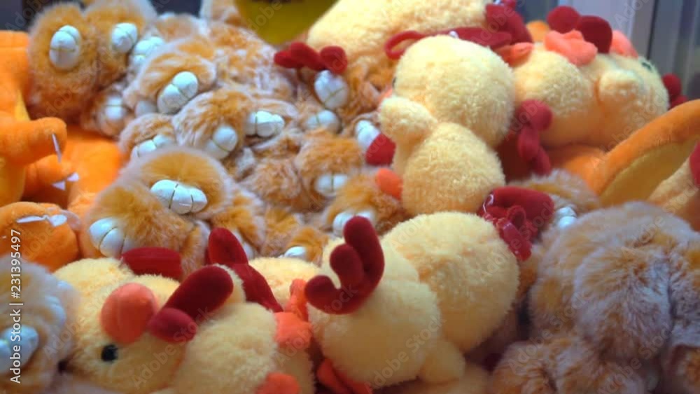Classic children's arcade game, claw grabs stuffed dolls prize Classic children's arcade game, claw grabs stuffed dolls prize