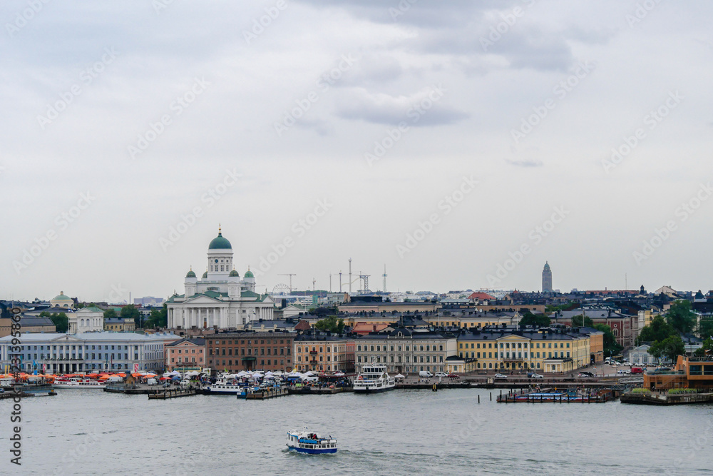 Helsinki southern port on a cloudy rainy day. View of the Helsinki Cathedral, the Presidential Palace and the market square from the ferry deck.