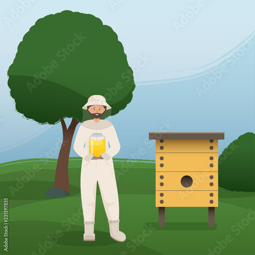 Beekeeper collects honey from bees. Beekeeper in a bee protection suit with a jar of honey.