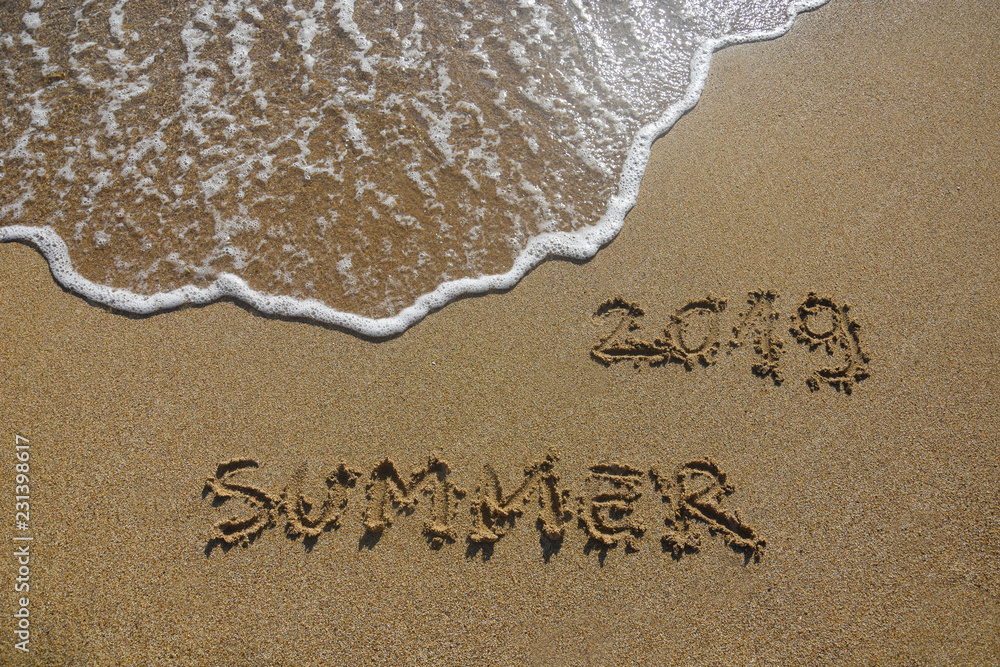 Fototapeta premium Summer vacation concept. Summer 2019 written on wet sand at the beach