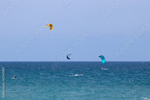 3 kite surfers in the ocean