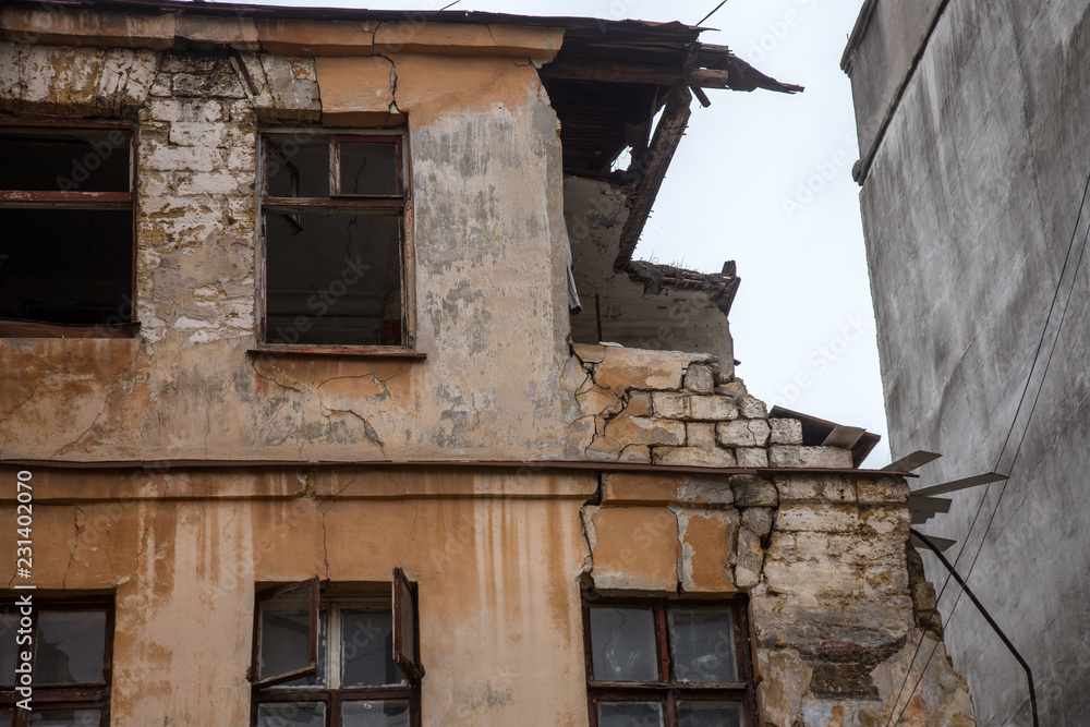 Ruins of an old abandoned city. Ruined house in which poor people live. Odessa, the ruins of a historic residential building. The ruins of an old earthquake-hit house. Lost city. Ruins of an old abandoned city. Ruined house in which poor people live. Odessa, the ruins of a historic residential building. The ruins of an old earthquake-hit house. Lost city.