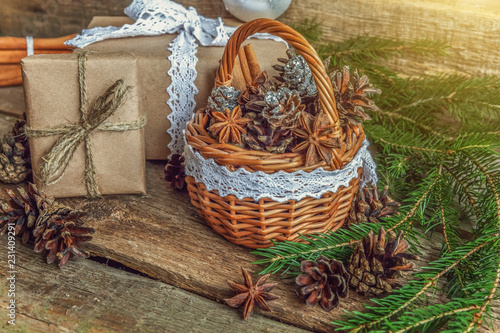 Christmas New Year composition with gift box fir branch basket pine cones on old shabby rustic wooden background. Xmas holiday december decoration to Russian tradition. Flat lay  copy space