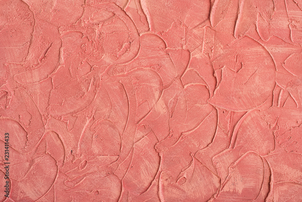 Fototapeta premium Relief stucco on the wall. Red color. Close up