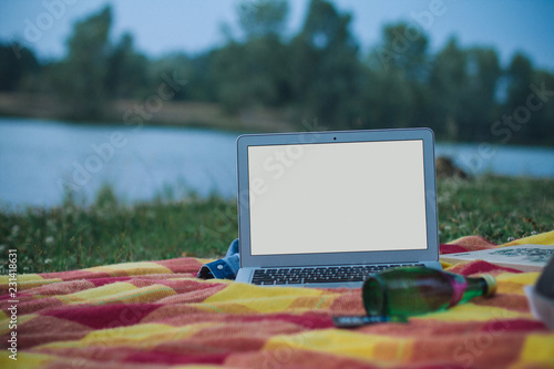 A laptop with solid screen outdoor with colorful background