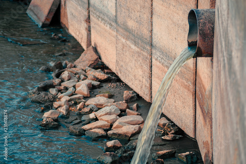 City Polluting the environment. Drainage pipe discharging waist products directly into the river