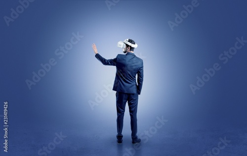 Businessman wearing vj glasse in an empty room with no wallpaper